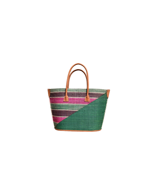 “Handmade raffia handbag from Madagascar featuring a deep green base with pink, plum, and natural striped design, finished with leather handles and reinforced corners.”