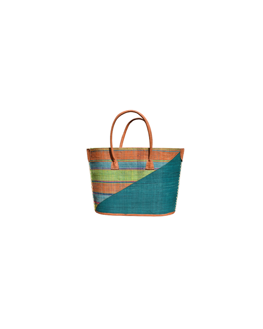 Front View:
“Handmade medium raffia handbag from Madagascar featuring a teal diagonal base with multicolored horizontal stripes in orange, green, and blue, finished with leather handles and reinforced corners.”