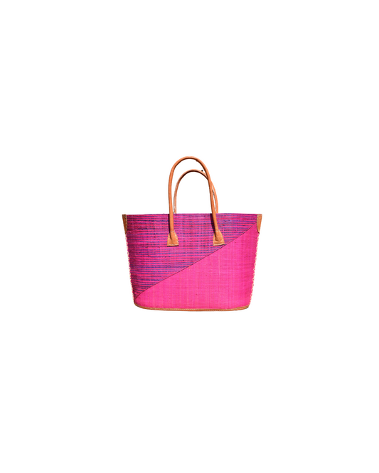 Front View:
“Handmade medium raffia handbag from Madagascar featuring a bright pink diagonal base with purple and pink striped upper section, finished with leather handles and reinforced corners.”