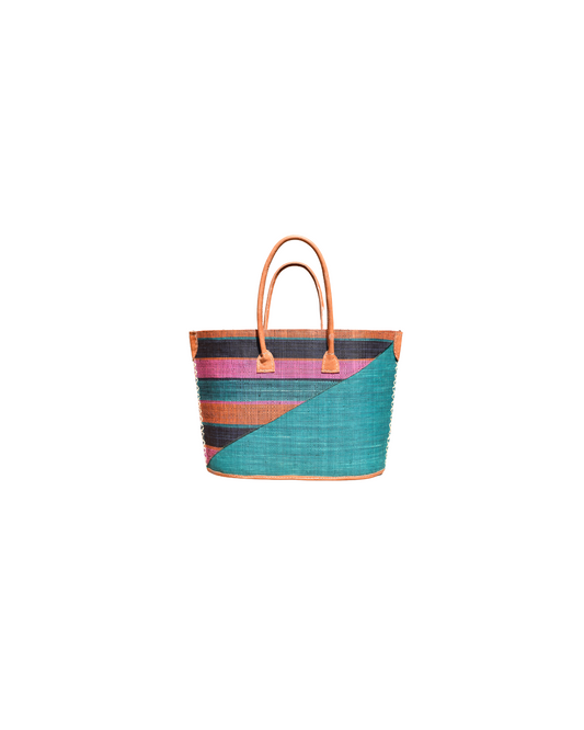 “Medium raffia handbag handmade in Madagascar with a diagonal design, teal base, and multicolored stripes in pink, orange, and black, featuring leather handles.”
