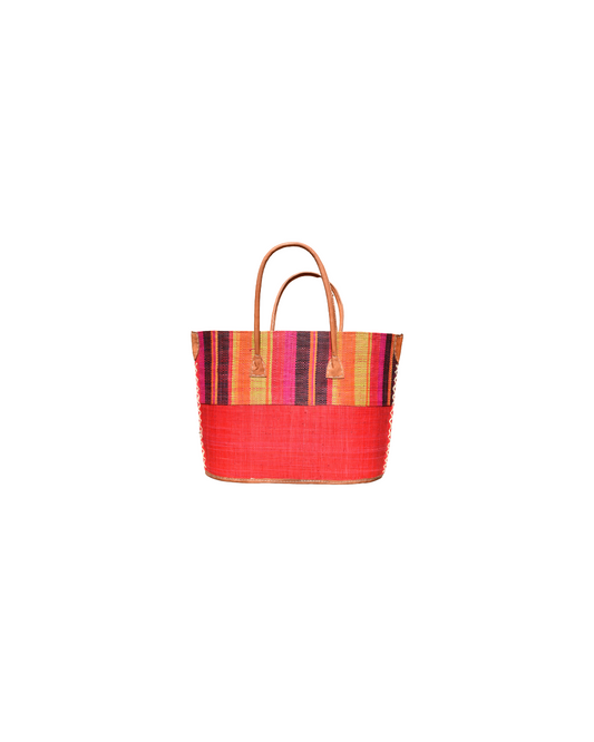 “Medium handmade raffia handbag with multicolor vertical stripes in red, orange, yellow, pink, and black, paired with a solid red lower panel and leather handles.”